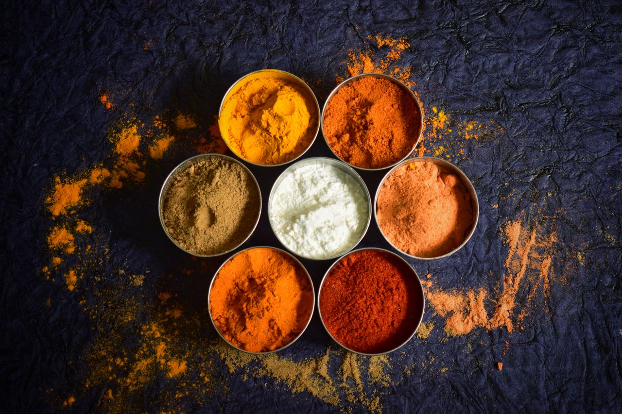 Crafting Captivating Headlines: Your awesome post title goes here Colorful Indian spices in bowls on a textured dark background for culinary concepts.