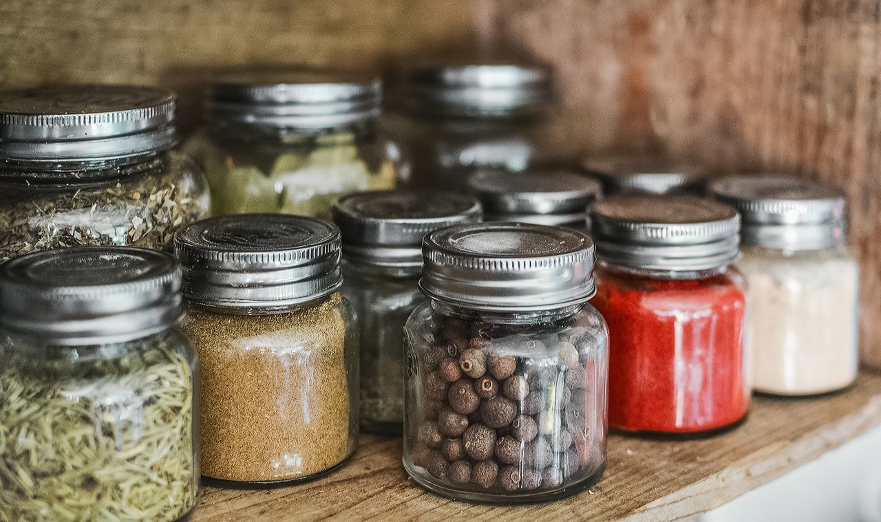The Art of Drawing Readers In: Your attractive post title goes here Close-up of assorted spice jars with various herbs on a kitchen shelf, showcasing colorful culinary ingredients.